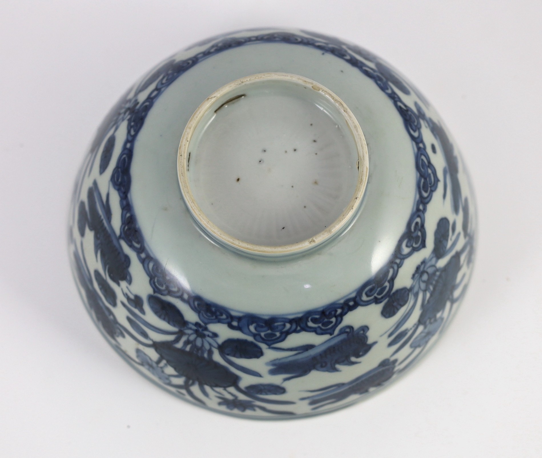 A Chinese Ming blue and white ‘lotus pond’ deep bowl, 21.5cm diameter, 10.5cm high, hairline crack to rim